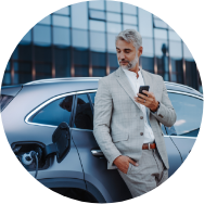 businessman-holding-smartphone-while-charging-car-2023-11-27-05-23-07-utc